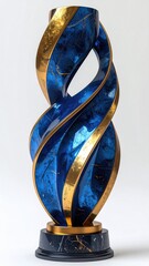 A tall, swirling sculpture with a dark blue and gold finish, resting on a dark marble base.  The design is intricate and resembles intertwined ribbons or flames