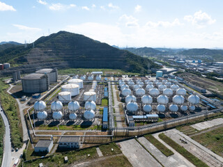Aerial views of industrial areas with numerous large storage tanks