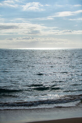 Calm sea water surface texture with splashes and waves. Abstract nature background. Background of aqua ocean water surface.