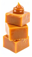 Three golden-brown caramel candies stacked, topped with a dollop of creamy caramel sauce, isolated on white
