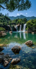 Naklejka premium Serene waterfall cascading into a crystal-clear pool, surrounded by lush greenery and imposing mountains under a vibrant blue sky