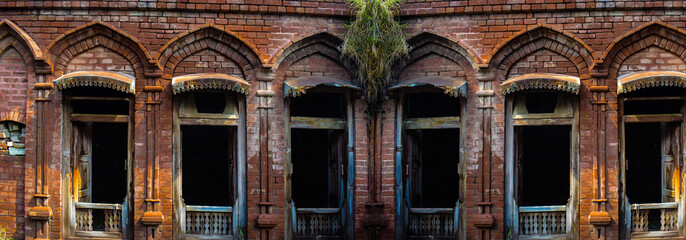A beautiful old wooden door on stone wall background, old entrance wooden double-leaf brown door...