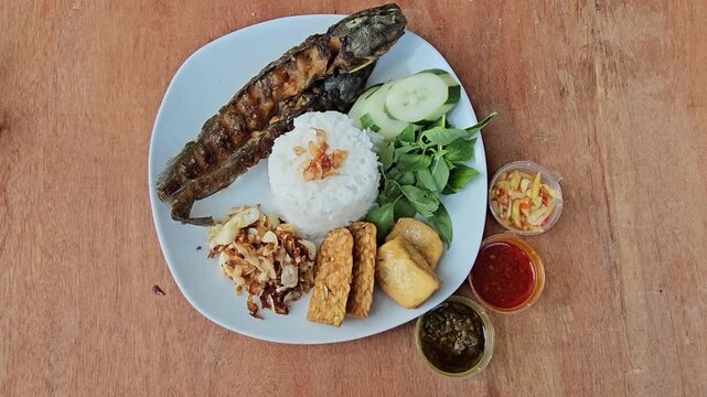 fresh fruit salad,Pecel lele set menu is deep fried Catfish served with rice,sliced cucumber,fresh indonesian basil and shrimp paste sambal or sambal terasi,additional menu fried tempeh and fried tofu