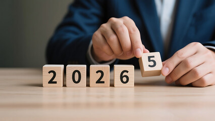 Businessperson placing a 2026 wooden block, representing new year's resolution