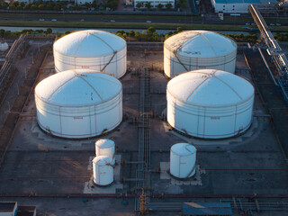 Aerial views of industrial areas with numerous large storage tanks