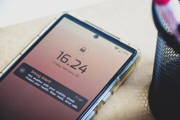 Smog alert reminder on mobile phone close-up on desk. Real-time notifications technology concept.