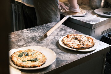 A chef is making traditional Italian pizza by hand