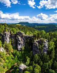 Obraz premium Rocky bridge over valley, lush forest