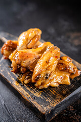 Honey glazed chicken wings on rustic board