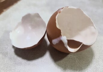 chicken cracked eggshell isolated on gray tabletop