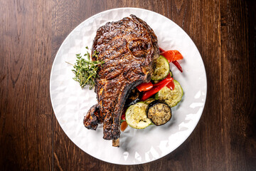 Grilled tomahawk steak with vegetables