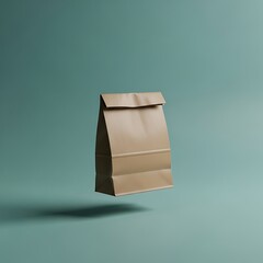A simple, kraft paper lunch bag floats against a muted teal background, showcasing its clean lines and subtle folds.