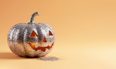 A shiny festive Halloween pumpkin with sequins falling out of its mouth on an orange background.  A Fun Halloween Day Concept