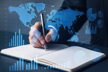 Close-up of Hand Writing in Notebook with Global Data and Financial Charts Overlay business finance