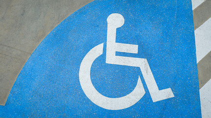 Wheelchair icon on road surface marking a dedicated lane for disabled access, symbolizing inclusion, accessibility, safety, and equality in urban transportation design.