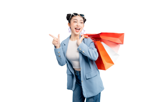 portrait Asian Woman  smiles brightly with shopping bags, pointing forward on PNG