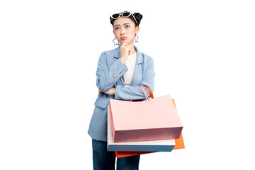 portrait Asian Woman  deep in thought while holding shopping bags. She is wearing a stylish outfit...