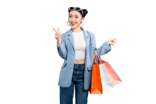 portrait Asian Woman joyfully shopping while holding shopping bags, with a peace sign on PNG