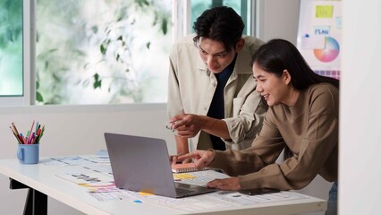 Creative Teamwork. Young professionals collaborating on project in modern office.