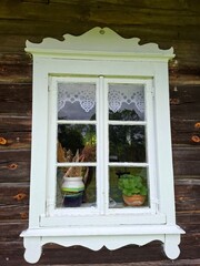 window in a housewindow of an old house The window is divided into multiple glass panes, and the paint on the frame shows signs of wear over time. 