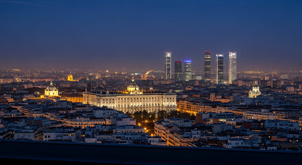 Obraz premium Panoramic night view of Moscow's cityscape with a river, bridges, and illuminated buildings under a dramatic dusk sky