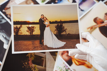 hands in white gloves and Beautiful printed wedding photos.