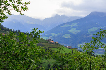 Cloudy mountain panorama with vineyards in Tirol (Dorf Tirol), South Tyrol, Italy