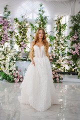 A bride at the table of the newlyweds, decorated with flowers