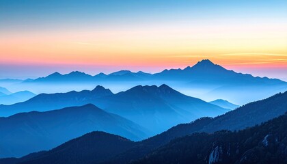 Obraz premium Majestic layered mountains fade into a light pink and blue sky at dusk, showcasing depth and atmospheric perspective