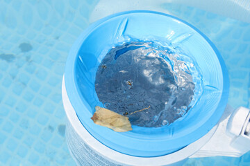 Top view of the blue skimmer for cleaning the pool in clear water. Contaminated pool cleaning concept