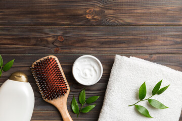 cosmetic for hair care, cream and towel on a colored background top view. flat lay