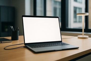 Fototapeta premium Modern laptop with blank white screen on wooden desk in bright office environment, ideal for branding mockup or digital design presentation template. Ai generative