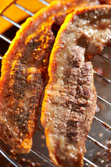 Well-grilled pork belly on the grill