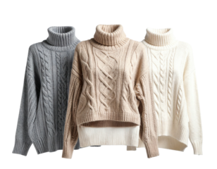 Three turtleneck cable knit sweaters in muted colors