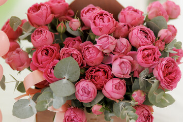 bouquet of deep pink blooming roses close up, natural background