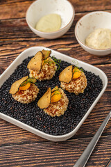 Gourmet quinoa balls with crispy texture and artistic garnish