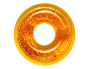 Circular, translucent yellow object with gold flecks and a hole