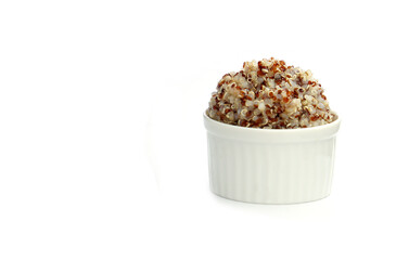 Quinoa soaked in boiling water until foamy. White, red, and black quinoa seeds in a bowl on a white background. Quinoa may help control blood sugar levels.