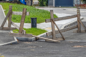 A broken temporary wooden fence on an autumn day