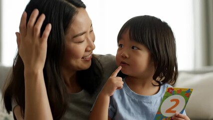 Close up mother teaching child count numbers two tongues cinematic handheld bilingual parenting stock video. maternal figure tutoring kid numeral dual language education handheld
