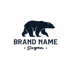 A minimalist dark blue silhouette of a walking bear above the text 