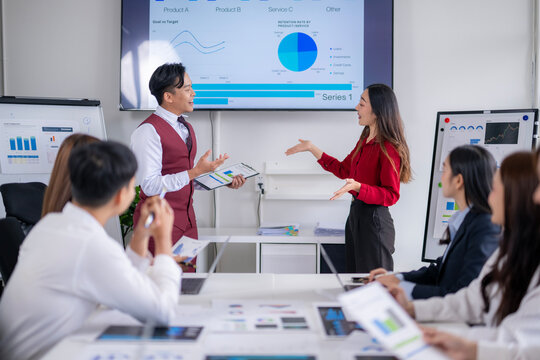 Asian business people presenting business data in meeting room