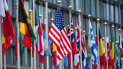 Obraz premium Flags of Unity: A vibrant array of diverse national flags waves proudly against the backdrop of a modern building, symbolizing international cooperation and global unity.