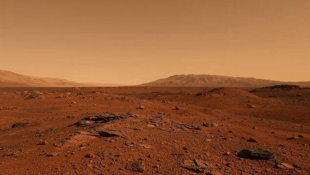 Expansive Martian desert terrain featuring scattered rocks and distant mountains beneath the hazy orange sky, captured within soft daylight with a wide panoramic perspective