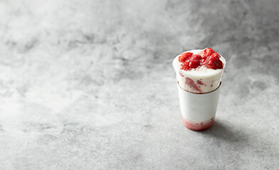 Iced strawberry latte in a takeout cup
