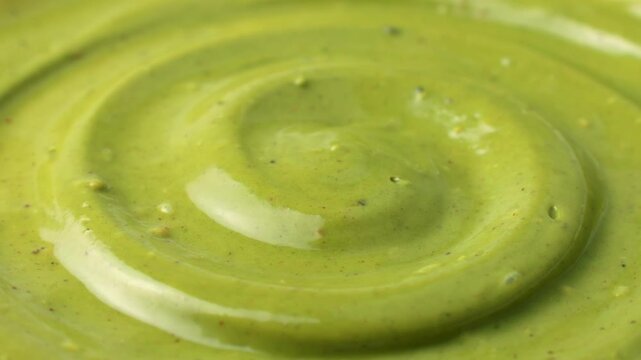 Green homemade pistachio paste texture circle rotation close up