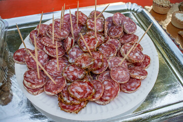 Sliced French salami served as a sample snack at a market