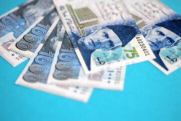 Pakistan rupees banknotes on blue background. The current Pakistan money bills