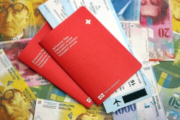 Swiss franc banknotes and passport with tickets. The current francs money bills and biometrical pass