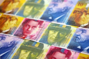 Swiss franc banknotes. The current francs money bills lies on table in big amount close up